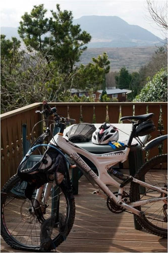 Mountain bike on the deck of a Cadair View Lodge log cabin in Snowdonia.  Accommodation is close to the trails.